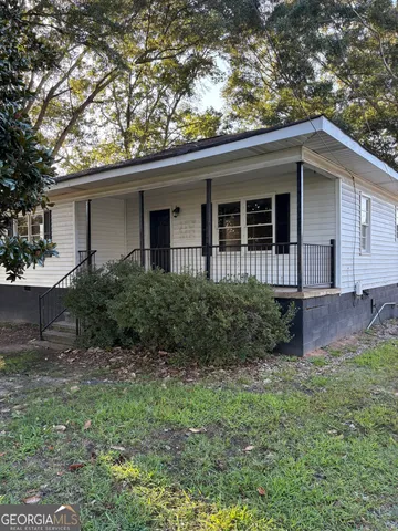 a view of a house with yard and a garden