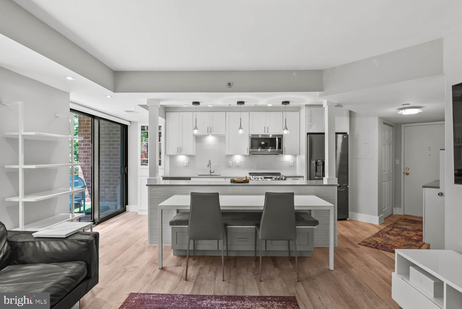 1401 17th Street Northwest, Unit 302 Washington, DC 20036 - Photo 2 of 2 a kitchen with stainless steel appliances granite countertop a stove and a refrigerator