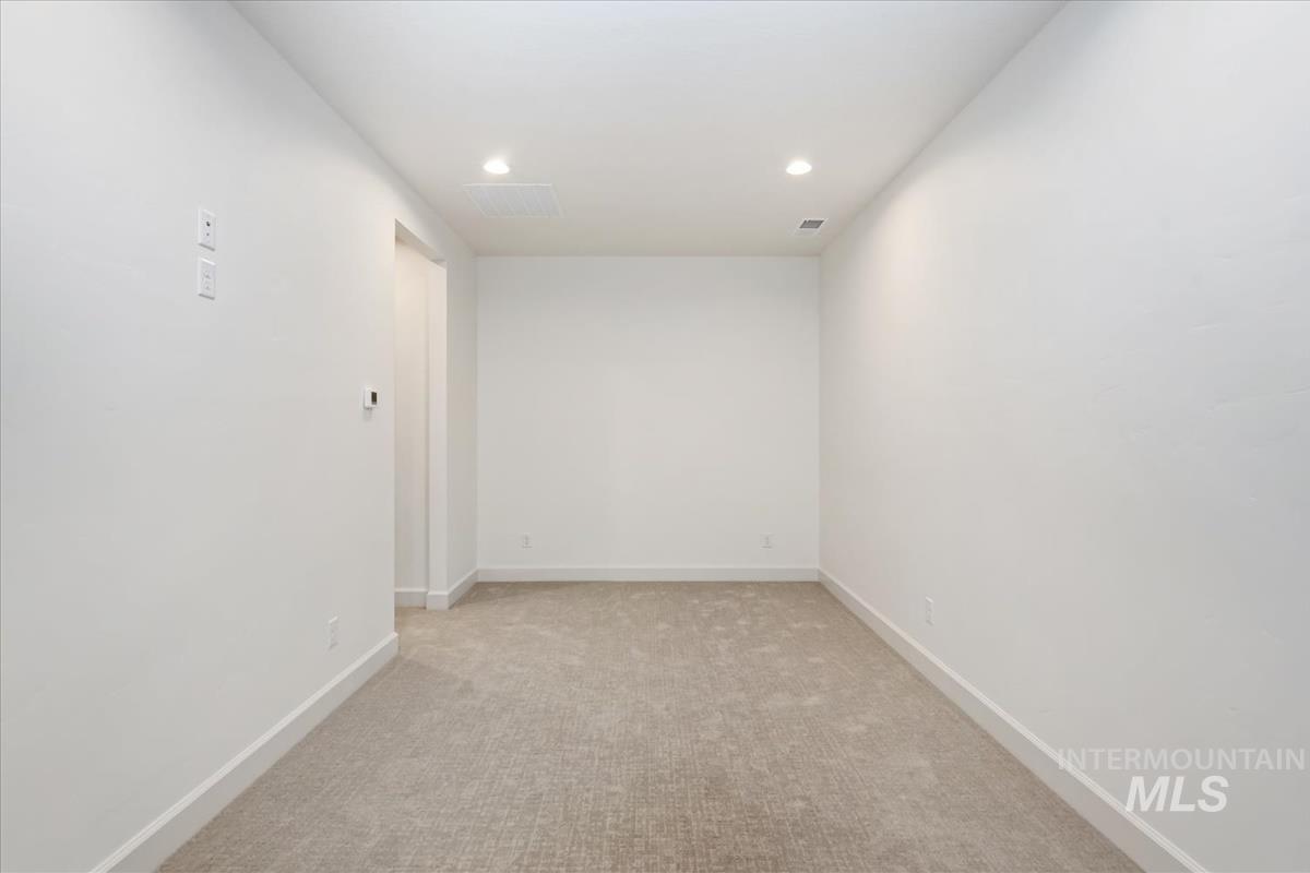 3300 North 39th Street Boise, ID 83703 - Photo 22 of 49 Empty room with light carpet and recessed lighting