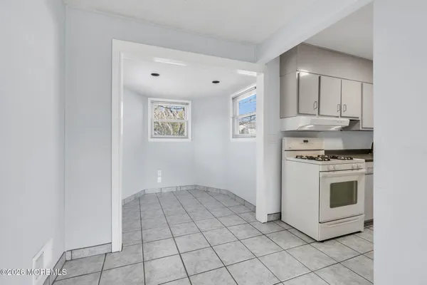 a view of a kitchen with white cabinets