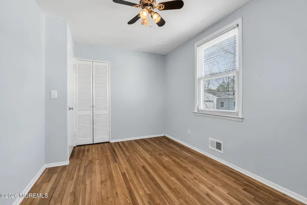 a view of a room with wooden floor and natural light