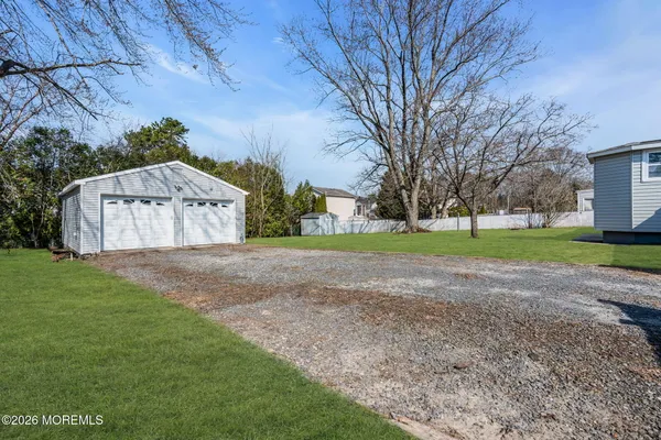 a view of house with backyard and garden