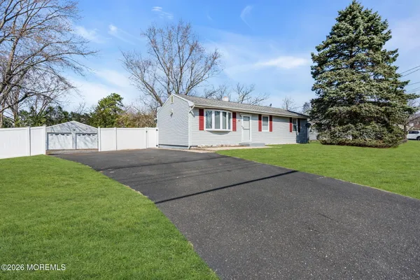 a front view of house with yard and green space