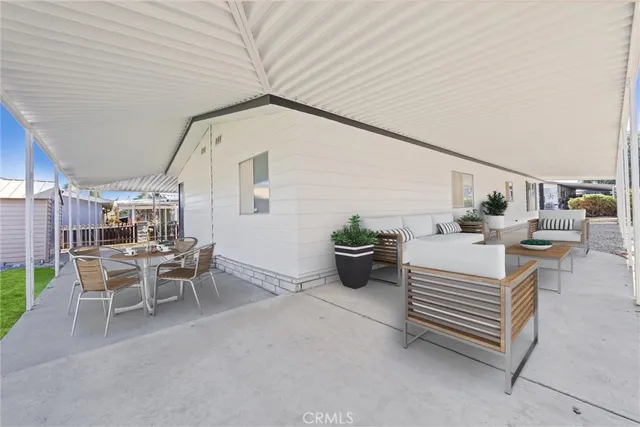a view of a patio with table and chairs