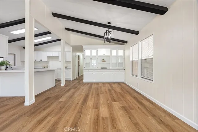 a view of a kitchen with cabinets and wooden floor