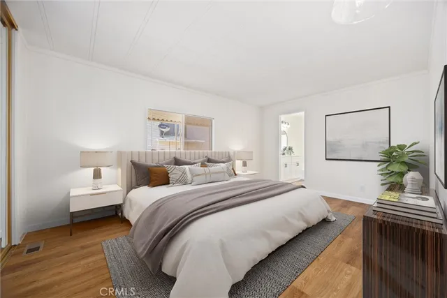 a bedroom with a bed and a potted plant