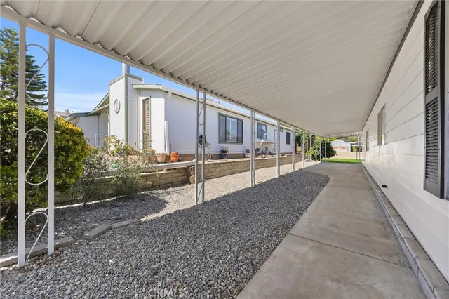 a view of a house with backyard and sitting area