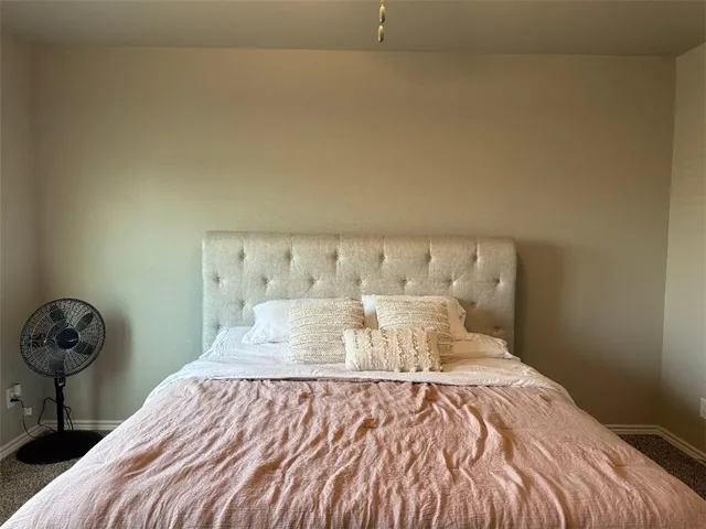 a bedroom with a bed and a table