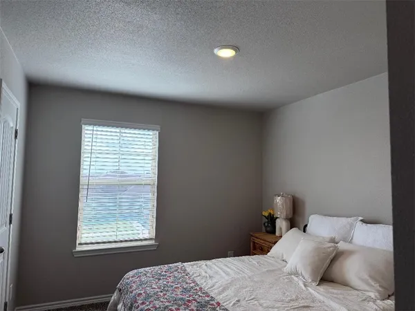 a bed room with a bed window and a lamp