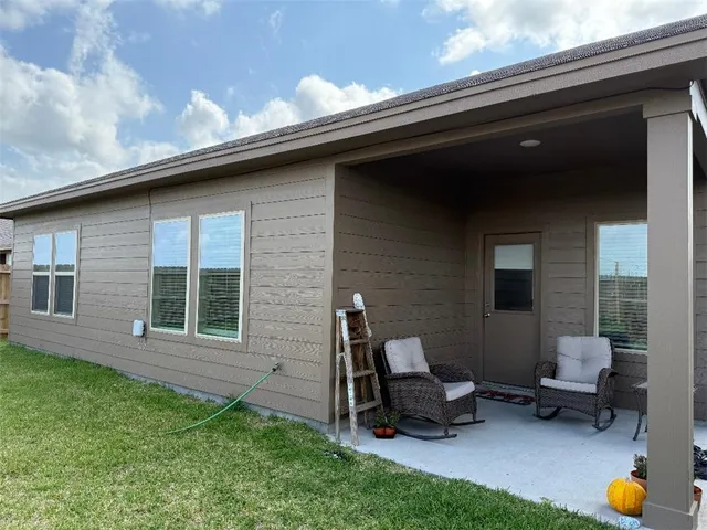 a view of house with yard and entertaining space