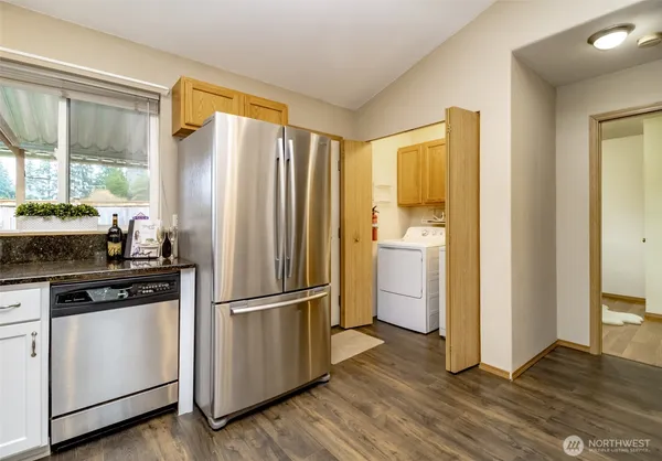 a kitchen with a refrigerator sink and cabinets