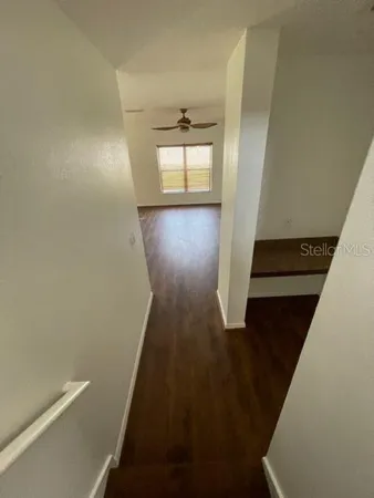 a view of entryway and hall with wooden floor