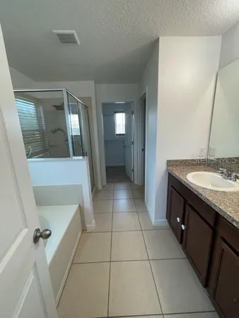 a bathroom with a granite countertop sink and mirror