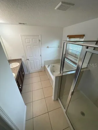 a kitchen with white cabinets and sink