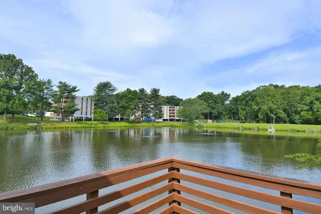 a front view of a building with parking space and a street light pole