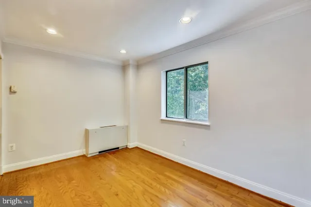 a view of a livingroom with a fireplace a chandelier and wooden floor