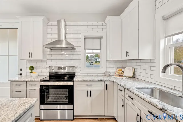 a kitchen with stainless steel appliances a stove sink microwave and cabinets