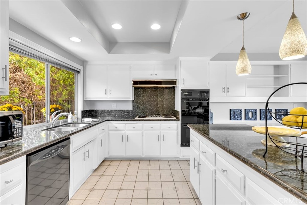 23211 Meadowbrook Circle Lake Forest, CA 92630 - Photo 11 of 50 a kitchen with stainless steel appliances granite countertop a sink counter space cabinets and a large window
