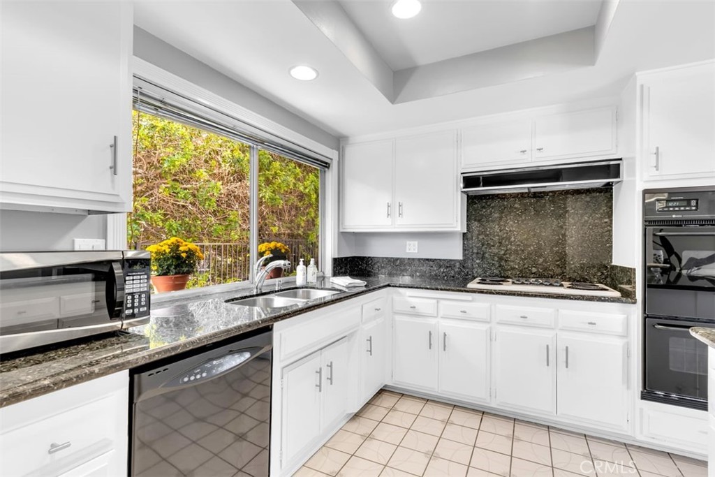23211 Meadowbrook Circle Lake Forest, CA 92630 - Photo 12 of 50 a kitchen with granite countertop a sink stainless steel appliances and cabinets