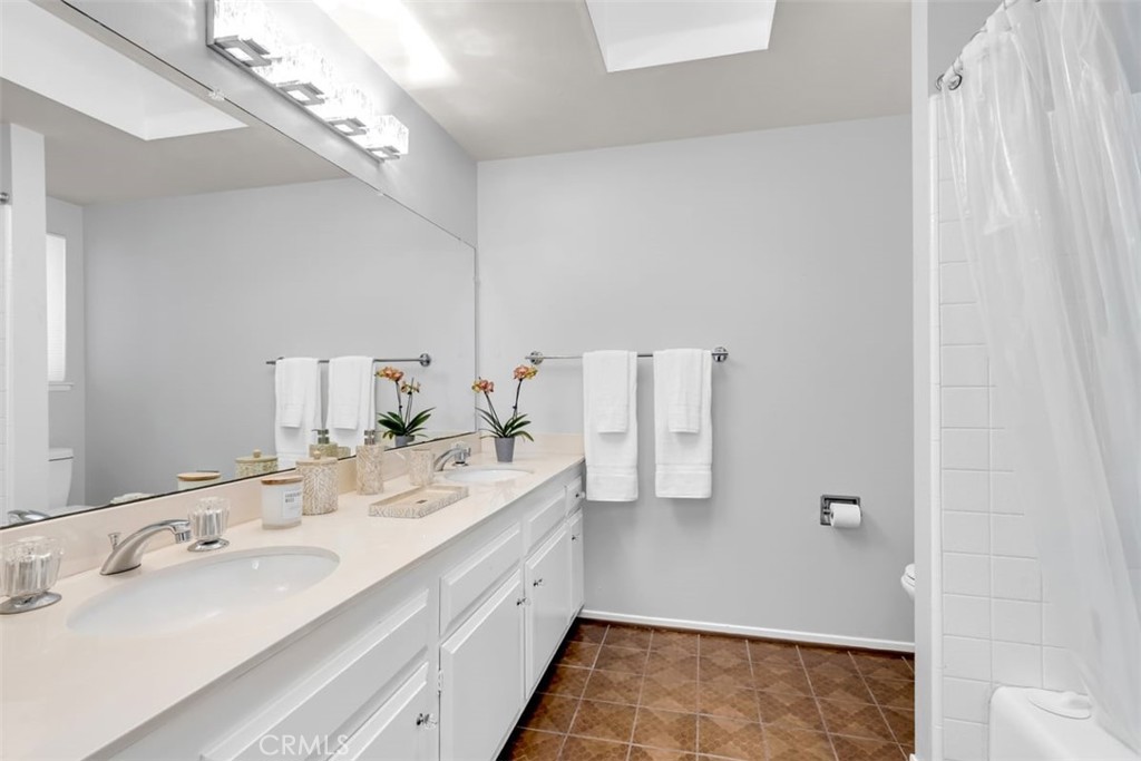 23211 Meadowbrook Circle Lake Forest, CA 92630 - Photo 28 of 50 a spacious bathroom with a double vanity sink and mirror