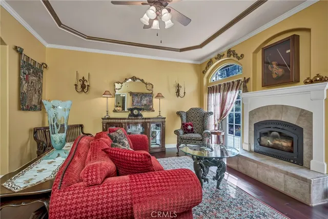 a living room with furniture a flat screen tv and a large window