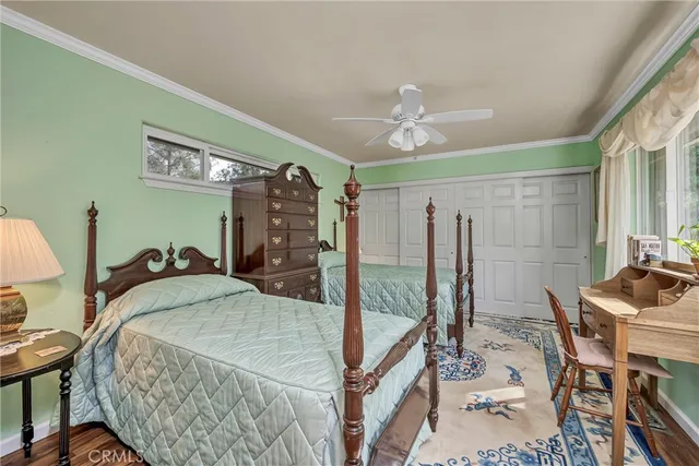 a bedroom with a large bed and a chandelier