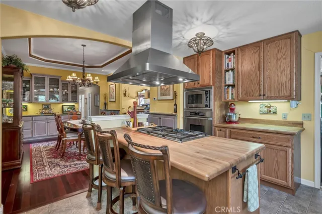 a view of a dining room with furniture a chandelier and wooden floor