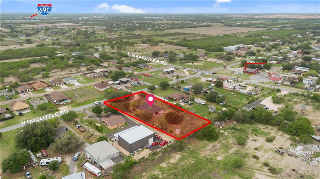 6020 North Doolittle Road Edinburg, TX 78542 - Photo 17 of 23 Aerial view showcasing a residential property outlined in red, featuring a single-story structure and surrounding natural landscape