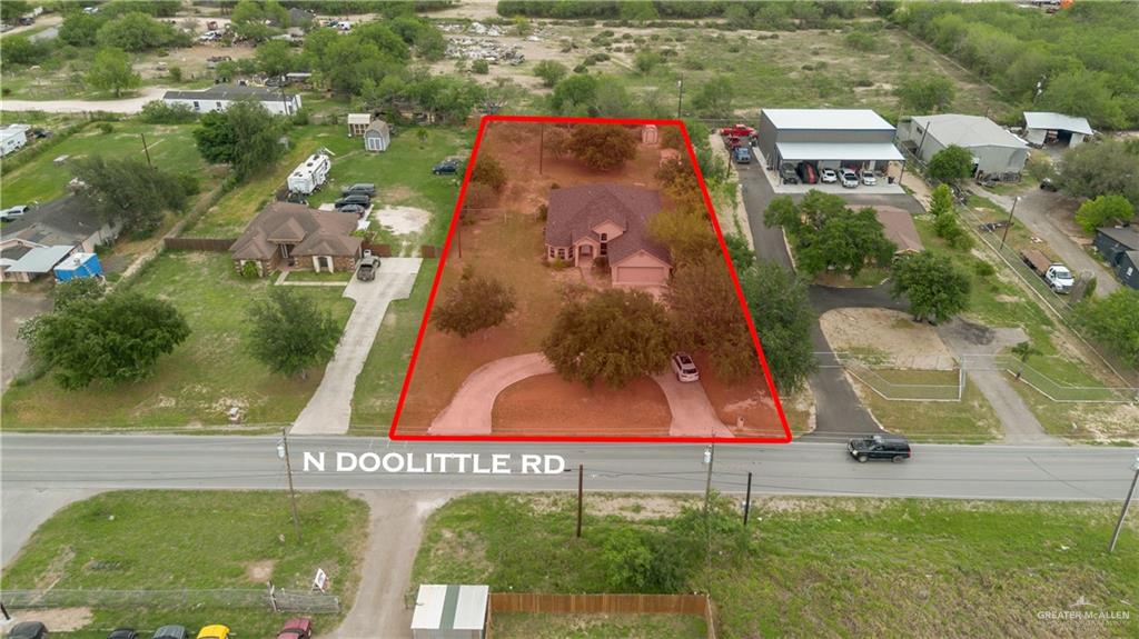 6020 North Doolittle Road Edinburg, TX 78542 - Photo 22 of 23 Single-story residence featuring a circular driveway, mature trees, and a two-car garage