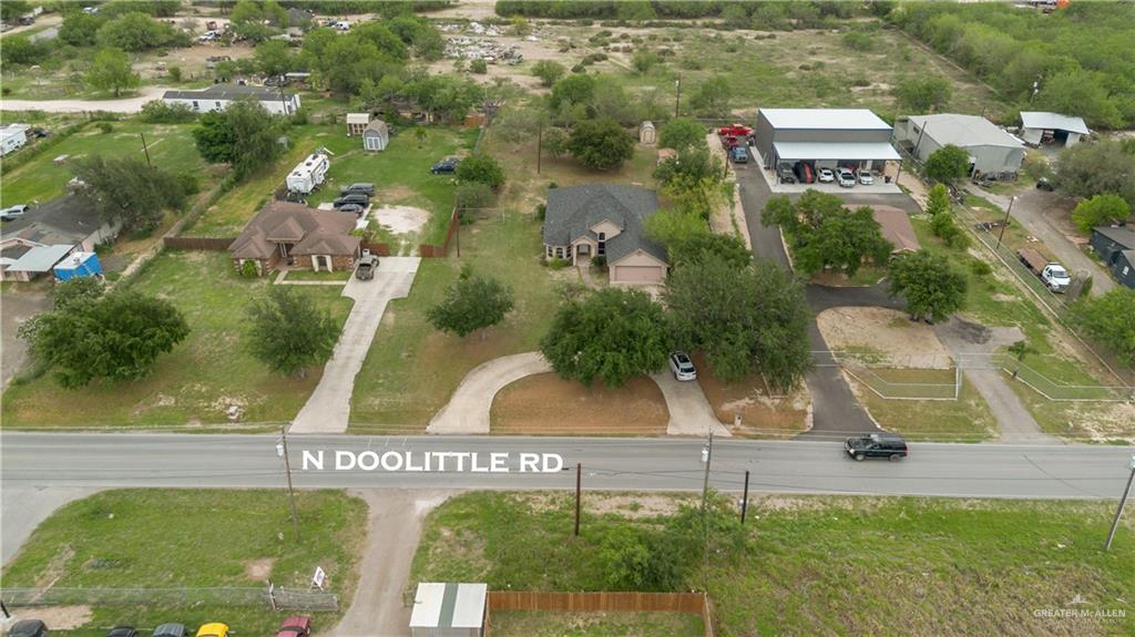 6020 North Doolittle Road Edinburg, TX 78542 - Photo 23 of 23 Aerial property overview featuring a single-story residence with a paved driveway, mature trees, and a spacious lot
