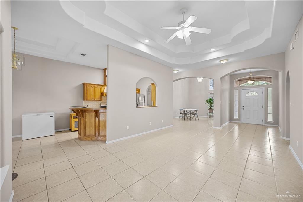 6020 North Doolittle Road Edinburg, TX 78542 - Photo 5 of 23 Spacious open-concept living area featuring a decorative tray ceiling, ceiling fan, and recessed lighting
