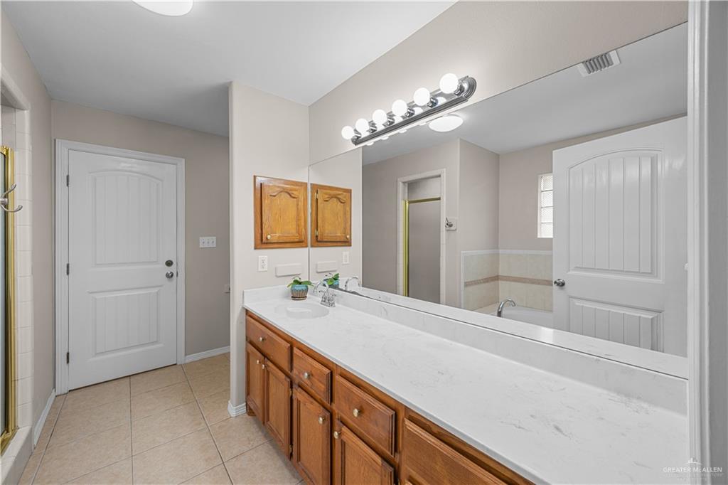 6020 North Doolittle Road Edinburg, TX 78542 - Photo 8 of 23 Extended vanity with a white countertop and wood-finish cabinetry