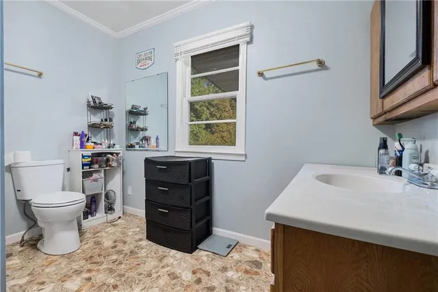 a bathroom with a sink toilet and a window