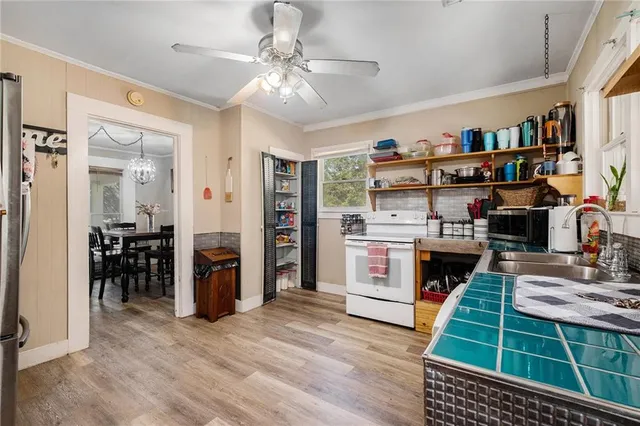 a kitchen with stainless steel appliances a stove a refrigerator and cabinets