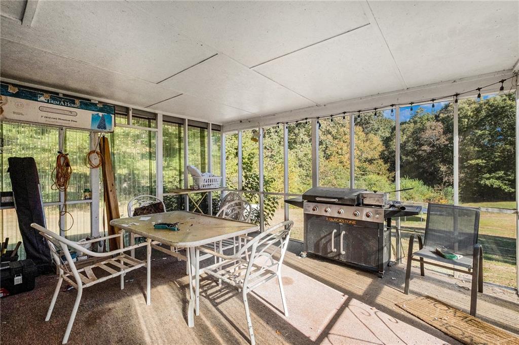 5831 Mize Road Toccoa, GA 30577 - Photo 20 of 28 a view of a dining room with furniture large windows and wooden floor