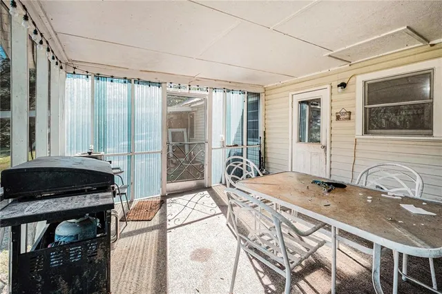 a bedroom with a bed and a dresser next to a window