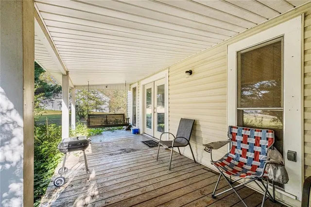 a balcony with furniture and wooden floor