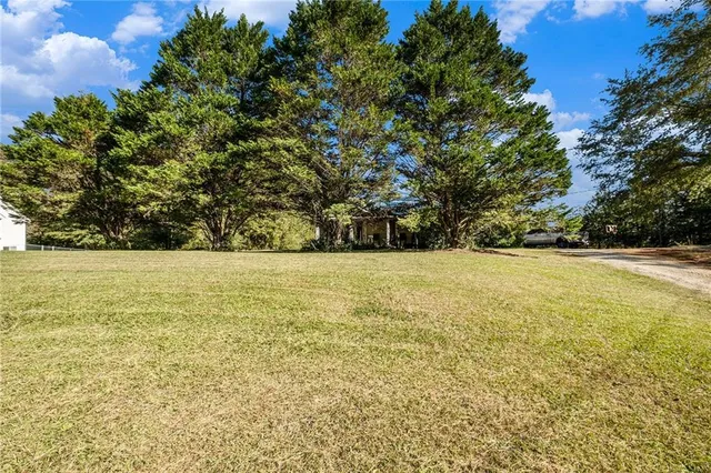 a view of outdoor space with swimming pool and green space