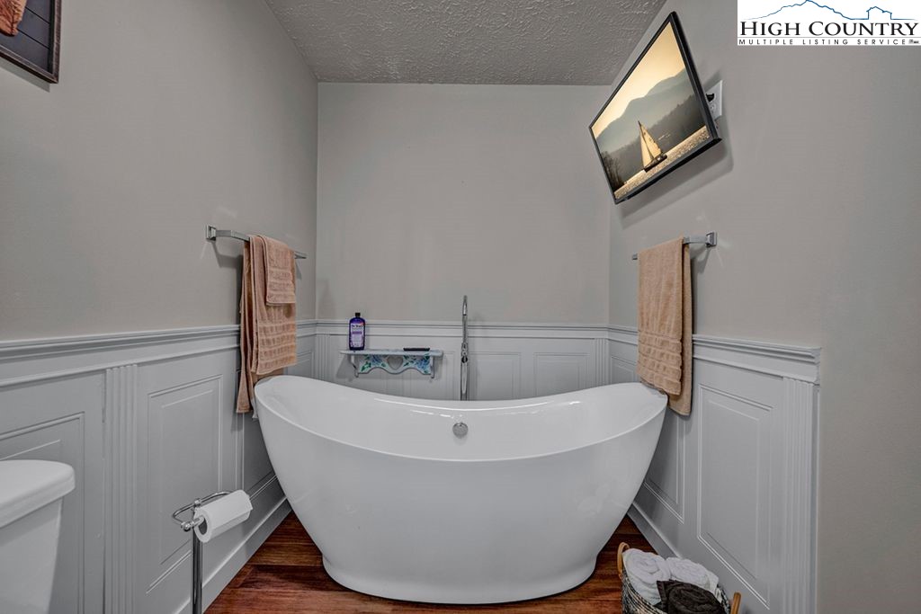 607 Charter Hills Road Beech Mountain, NC 28604 - Photo 11 of 31 a white bath tub sitting next to a white toilet