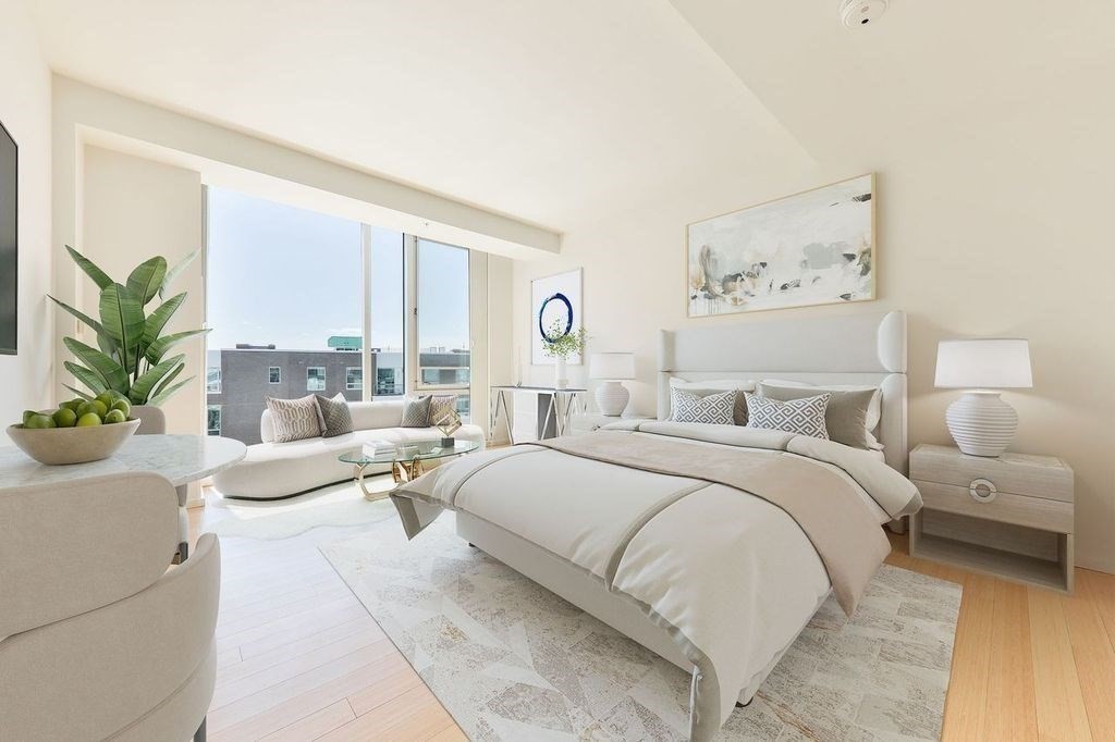 a bedroom with a large bed and a large window