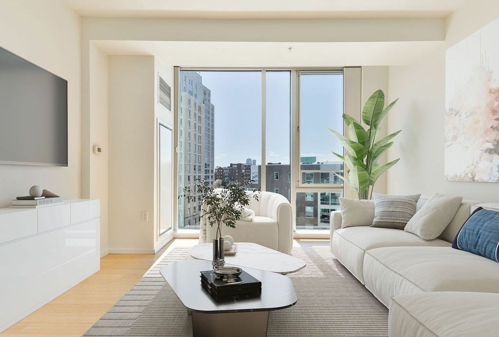 2 Earhart Street, Unit 720 Cambridge, MA 02141 - Photo 17 of 40 a living room with furniture potted plant and a large window