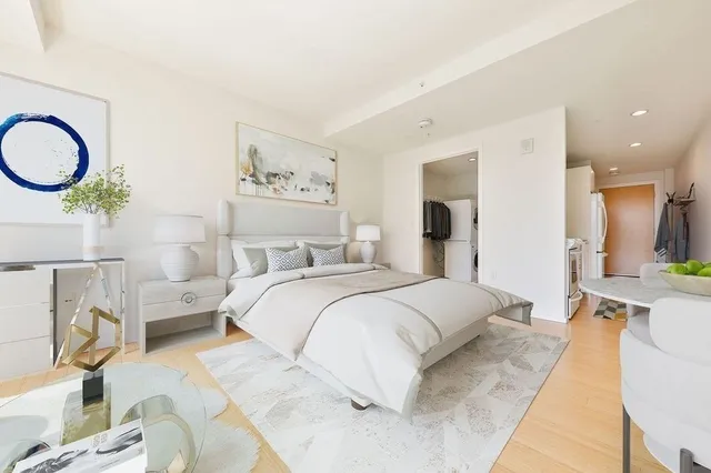 a bedroom with a bed and dresser