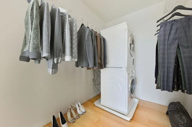 a view of walk in closet with clothes and shoes