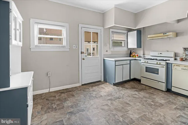 a kitchen with a stove top oven and cabinets