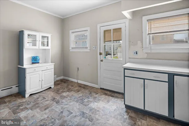 a room with a sink cabinets and a window