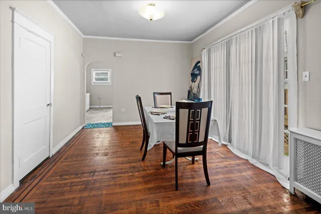 a view of a room with wooden floor lounge chair and windows