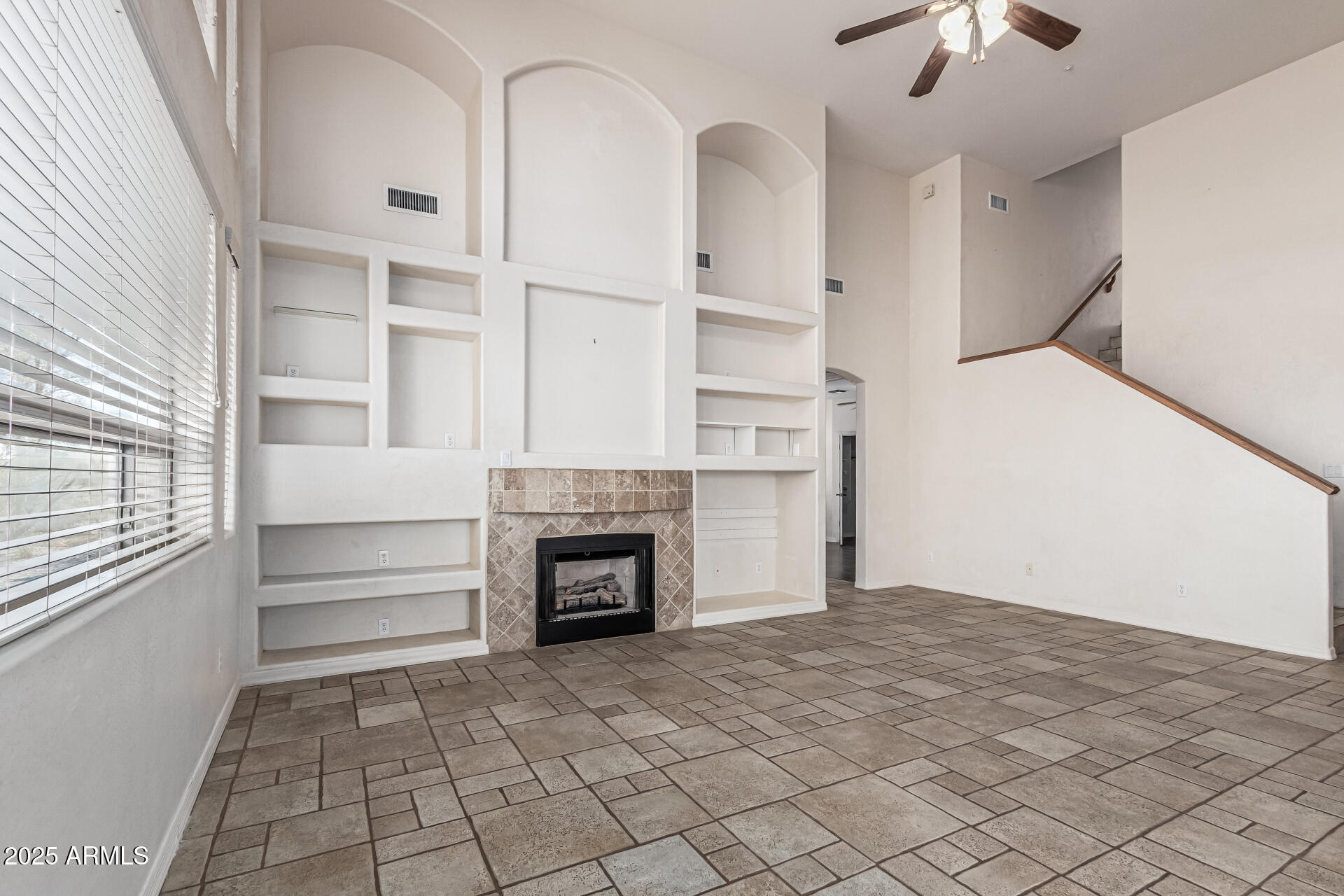 15639 West Peak View Road Surprise, AZ 85387 - Photo 24 of 131 a view of empty room with a fireplace