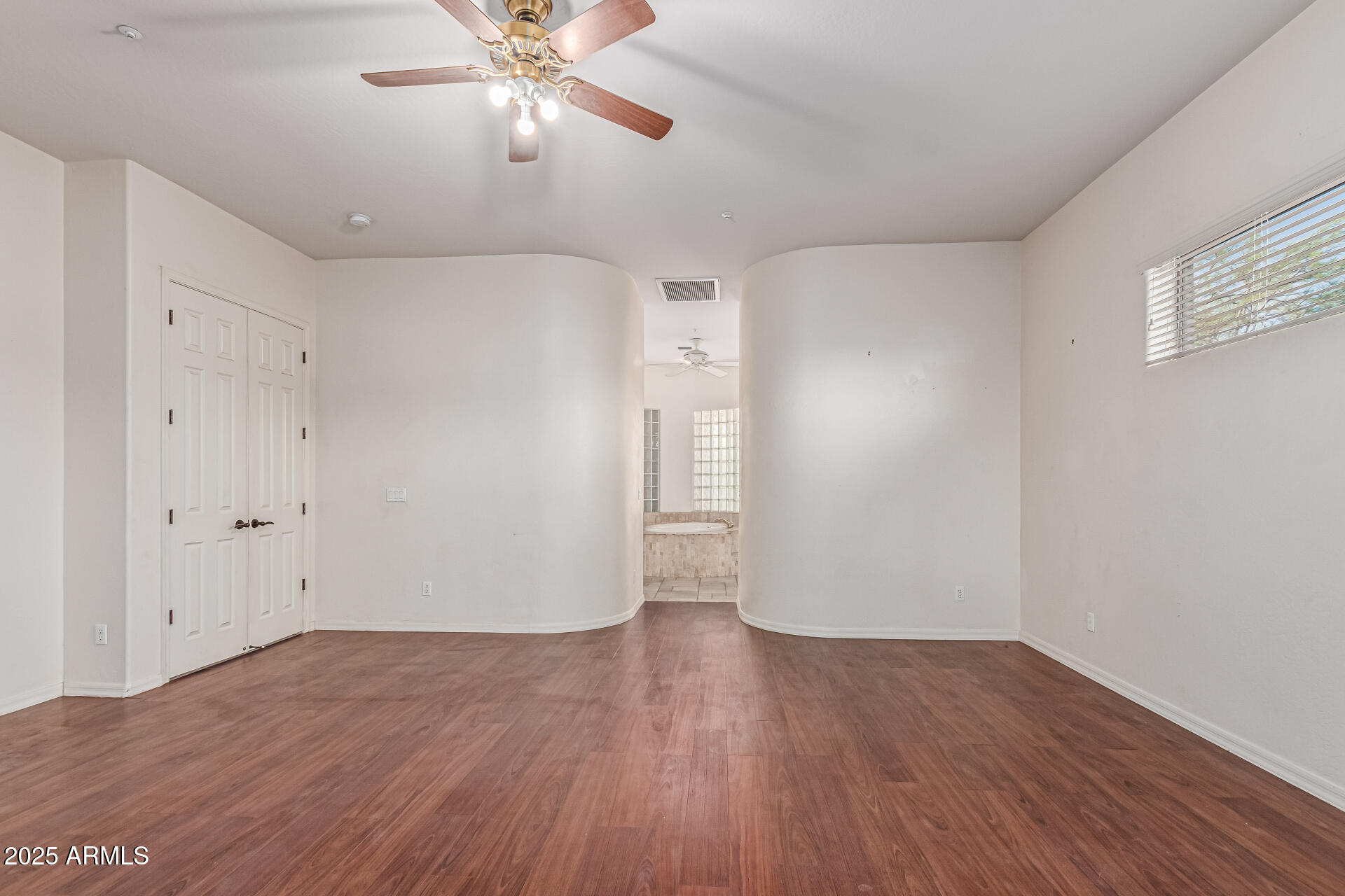 15639 West Peak View Road Surprise, AZ 85387 - Photo 44 of 131 a view of an empty room with wooden floor