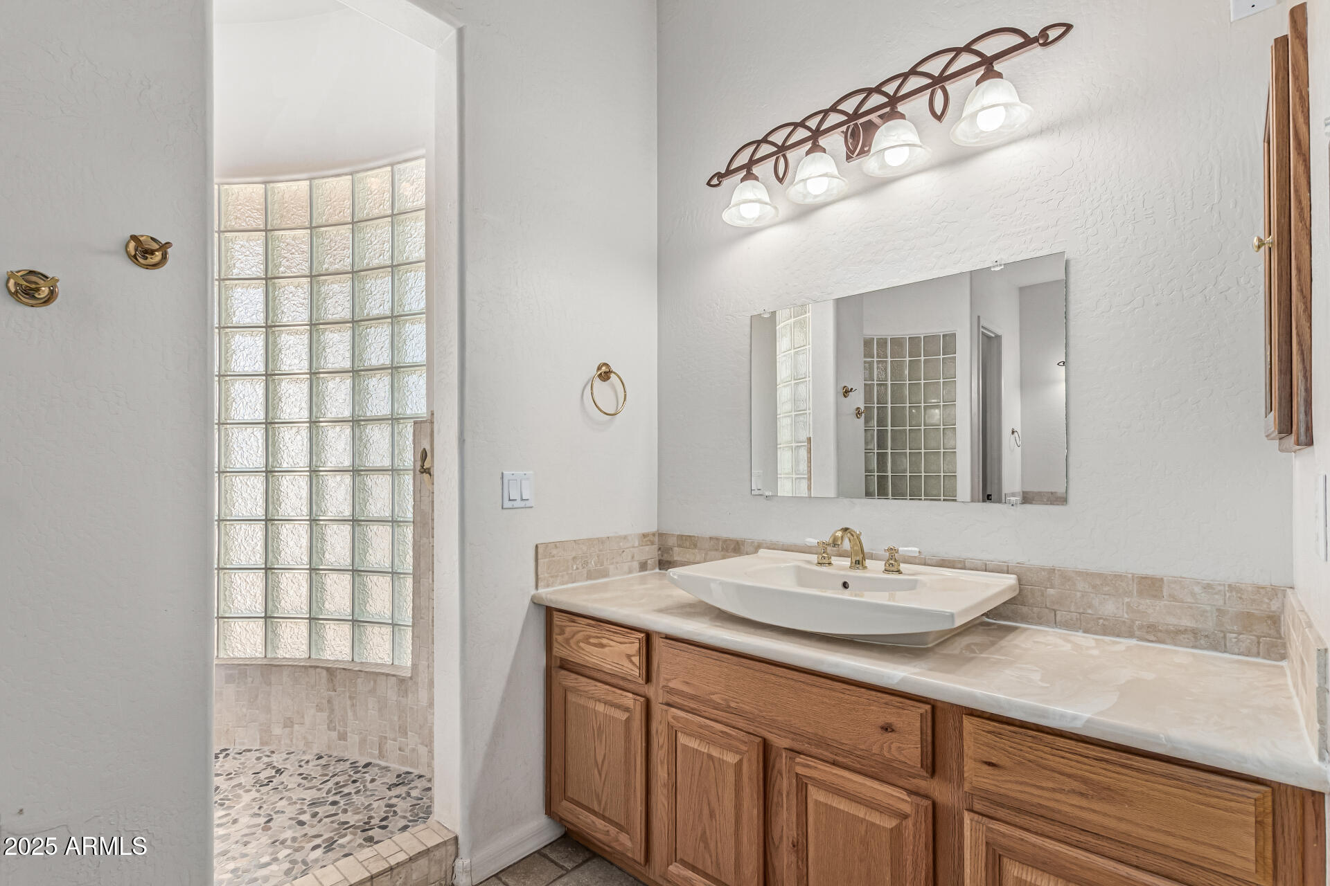 15639 West Peak View Road Surprise, AZ 85387 - Photo 45 of 131 a bathroom with a sink and a mirror