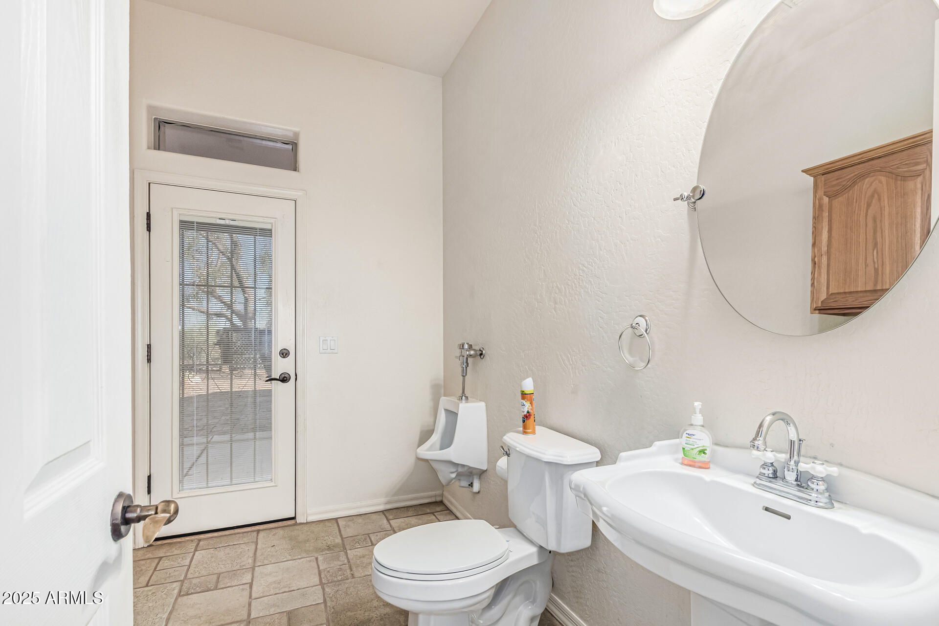 15639 West Peak View Road Surprise, AZ 85387 - Photo 65 of 131 a bathroom with a toilet a sink and glass door